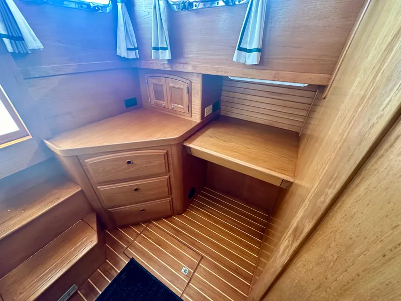 Slide: The Image of 1997 Sabre Cockpit Motor Yacht interior with wooden cabinetry and flooring. - 26