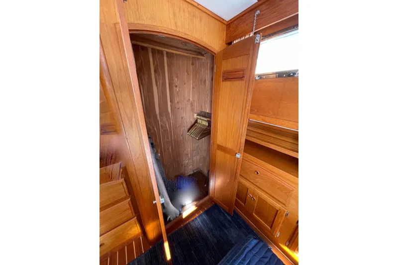 Slide: The Image of 1997 Sabre interior with wooden cabinetry and open closet space. - 27