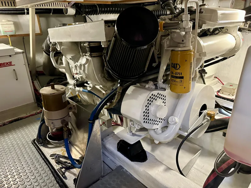 Slide: The Image of Engine room of a 1997 Sabre Cockpit Motor Yacht, showcasing mechanical components and filters. - 36