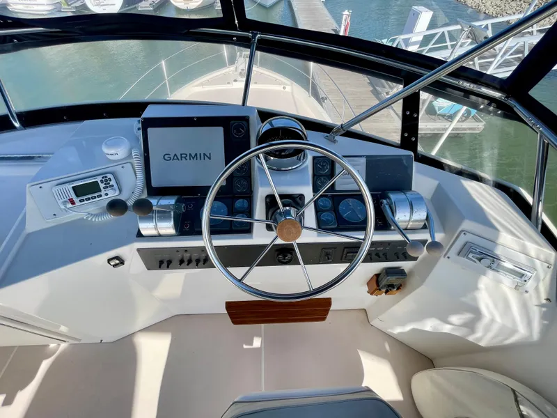 Slide: The Image of Cockpit of 1997 Sabre Motor Yacht with Garmin navigation system and steering wheel. - 38