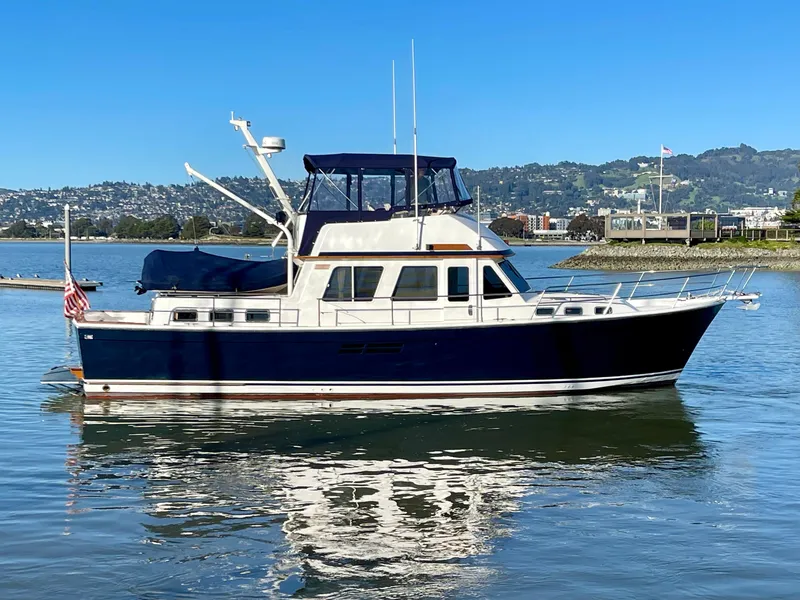 Slide: The Image of 1997 Sabre Cockpit Motor Yacht on calm water, clear sky background. - 8