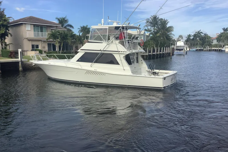 Slide: The Image of 1994 Viking 50' Convertible Sportfish yacht cruising in a scenic canal setting. - 10