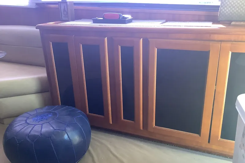 Slide: The Image of Interior of 1994 Viking 50' Convertible Sportfish with wooden cabinetry and blue pouf. - 16