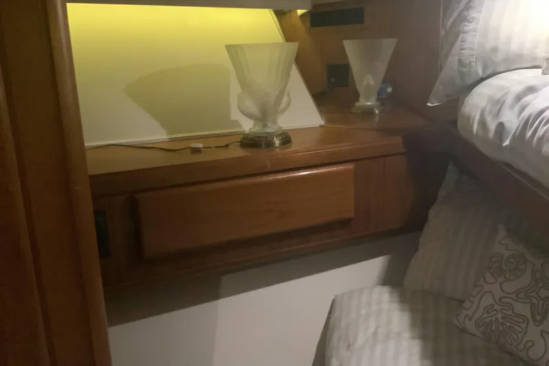 Slide: The Image of Interior cabin of 1994 Viking 50' Convertible Sportfish with wooden cabinetry and soft lighting. - 22