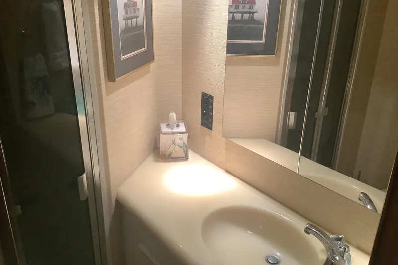 Slide: The Image of Bathroom interior of 1994 Viking 50' Convertible Sportfish yacht with sink and mirror. - 25