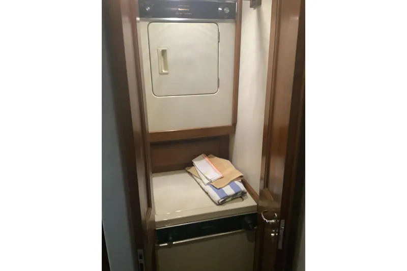 Slide: The Image of Laundry area inside 1994 Viking 50' Convertible Sportfish yacht, featuring washer and dryer. - 29