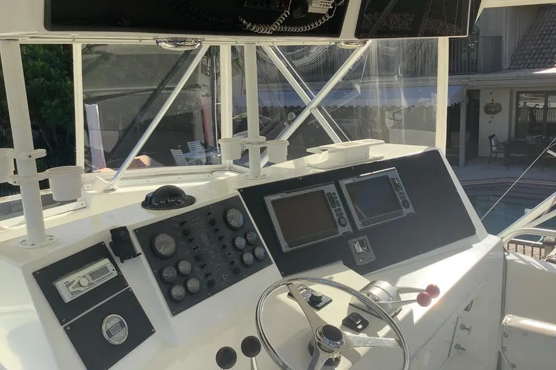 Slide: The Image of Control panel of a 1994 Viking 50' Convertible Sportfish boat, featuring navigation instruments. - 3