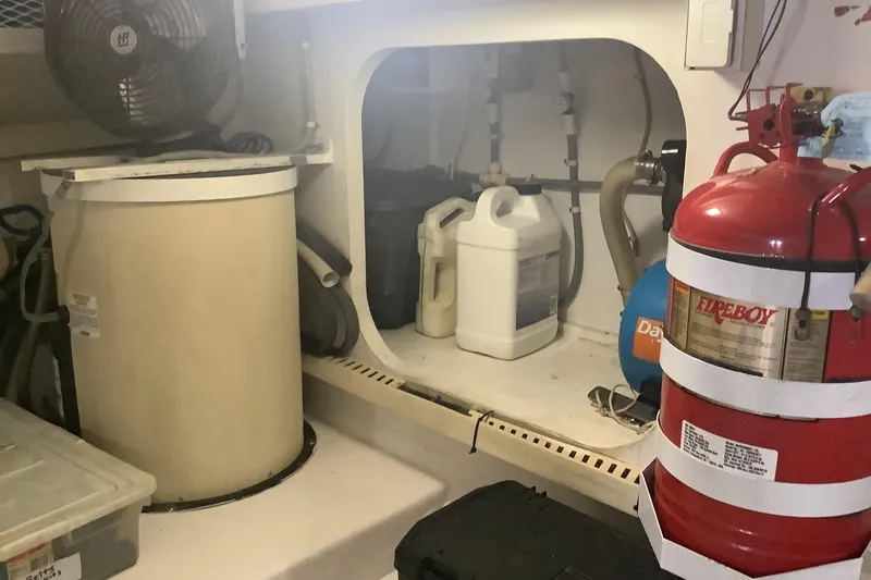 Slide: The Image of Engine room of 1994 Viking 50' Convertible Sportfish with fire extinguisher and equipment. - 33