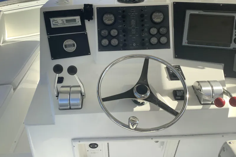 Slide: The Image of 1994 Viking 50' Convertible Sportfish helm with steering wheel and control panel. - 4
