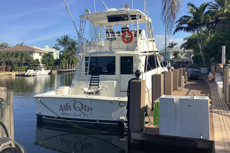 Slide: The Image of 1994 Viking 50' Convertible Sportfish docked in a sunny marina setting. - 9