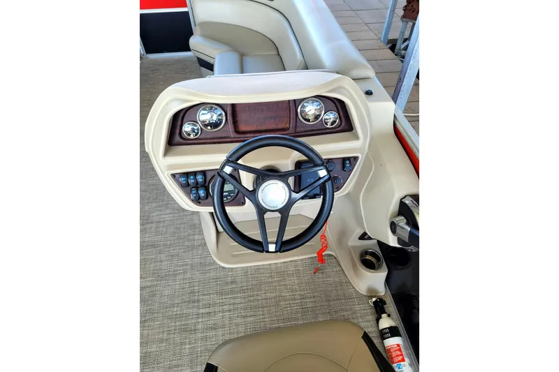 Slide: The Image of 2023 Berkshire 24CL LE 2.75 boat dashboard with steering wheel and controls. - 11