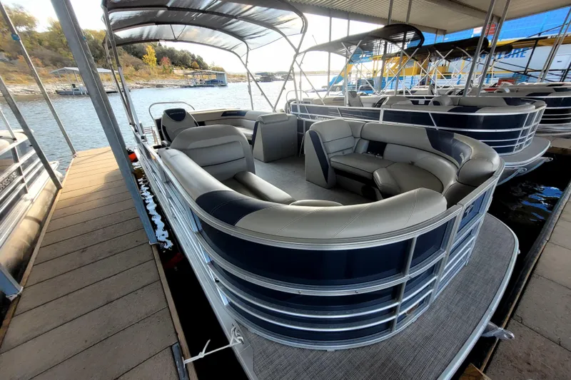 Slide: The Image of 2023 Berkshire 24CL LE 2.75 pontoon boat docked, featuring spacious seating and sleek design. - 3