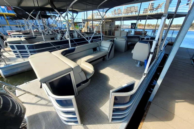 Slide: The Image of 2023 Berkshire 24CL LE 2.75 pontoon boat with spacious seating and modern design at dock. - 8
