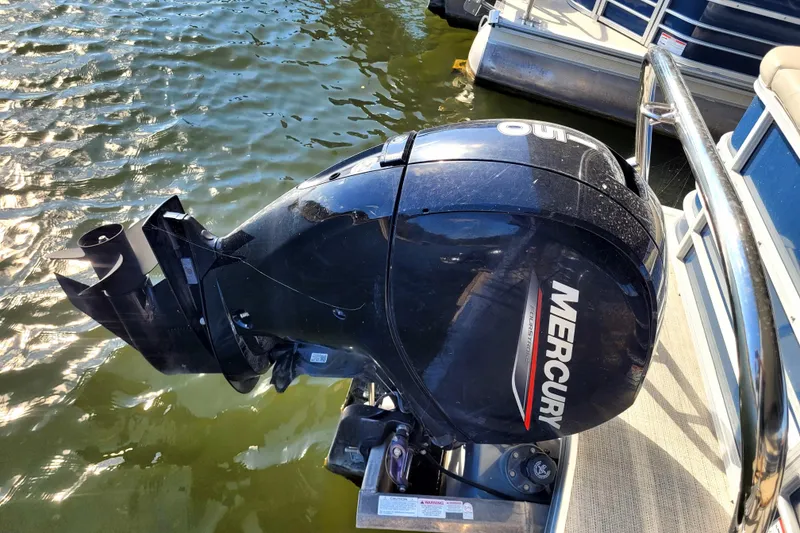 Slide: The Image of 2023 Berkshire 24CL LE 2.75 pontoon boat with Mercury outboard motor on water. - 9