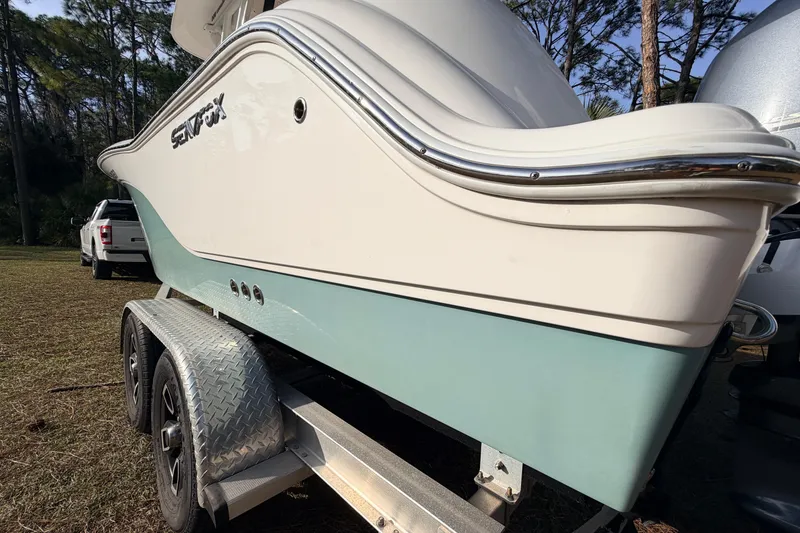 Slide: The Image of 2022 Sea Fox 228 Commander boat on trailer, parked outdoors. - 10