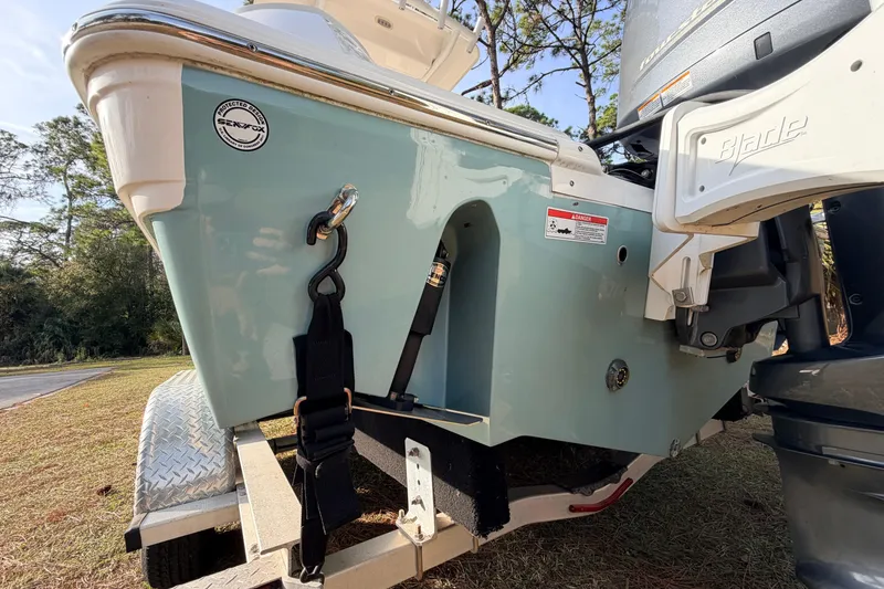 Slide: The Image of 2022 Sea Fox 228 Commander boat on trailer, rear view with motor and strap details. - 11