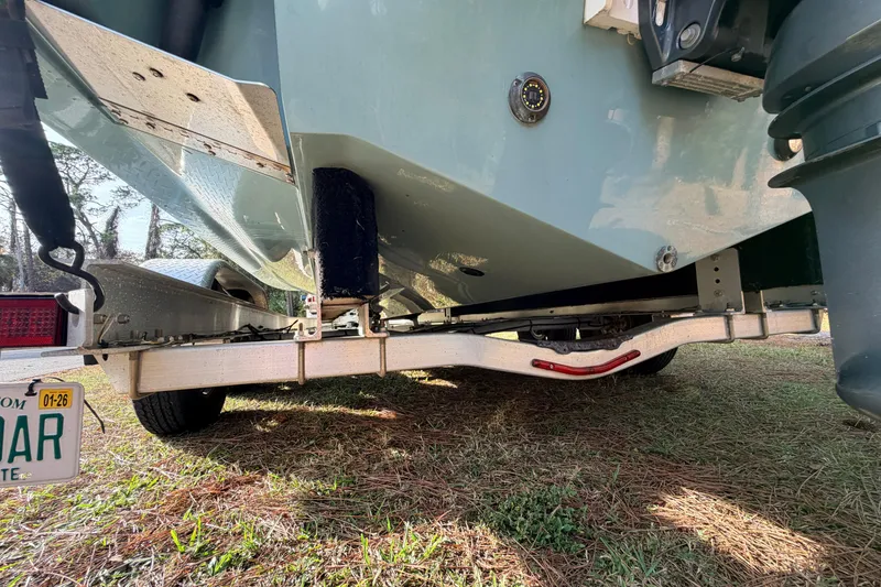 Slide: The Image of 2022 Sea Fox 228 Commander boat on trailer, rear view, parked on grass. - 12