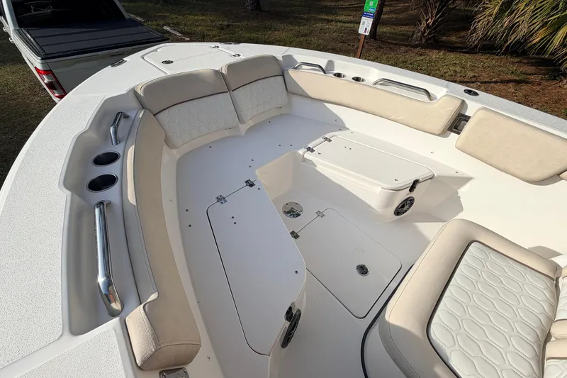 Slide: The Image of 2022 Sea Fox 228 Commander boat interior with cushioned seating and storage compartments. - 22