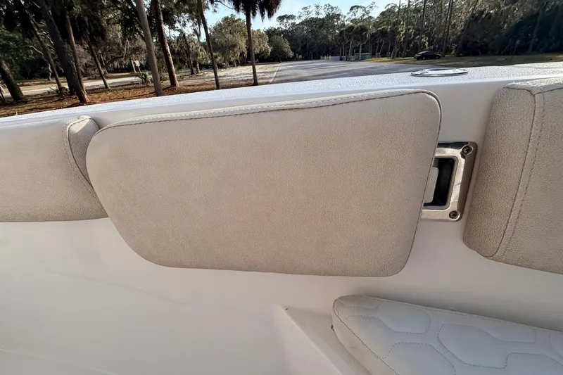 Slide: The Image of 2022 Sea Fox 228 Commander boat interior with cushioned seating and scenic background. - 30