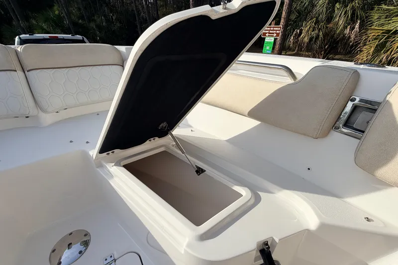 Slide: The Image of 2022 Sea Fox 228 Commander boat with open storage compartment and cushioned seating. - 38