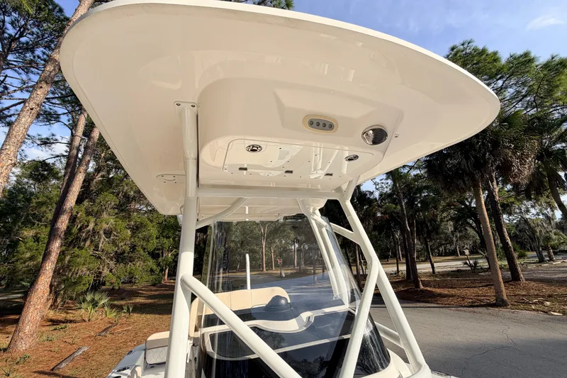 Slide: The Image of 2022 Sea Fox 228 Commander boat with T-top, surrounded by trees. - 44