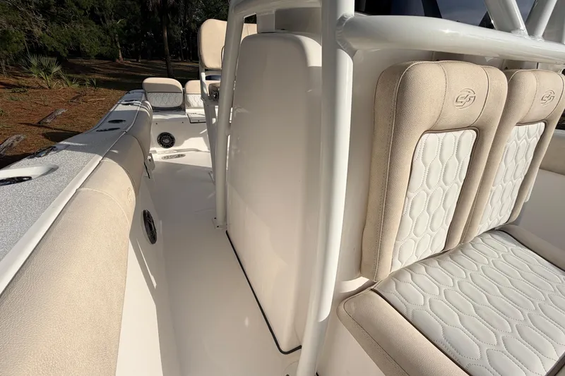 Slide: The Image of 2022 Sea Fox 228 Commander boat interior with beige cushioned seating and sleek design. - 46