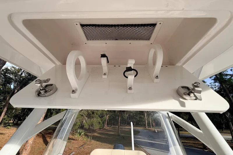 Slide: The Image of 2022 Sea Fox 228 Commander boat's overhead storage with rod holders and latches. - 48