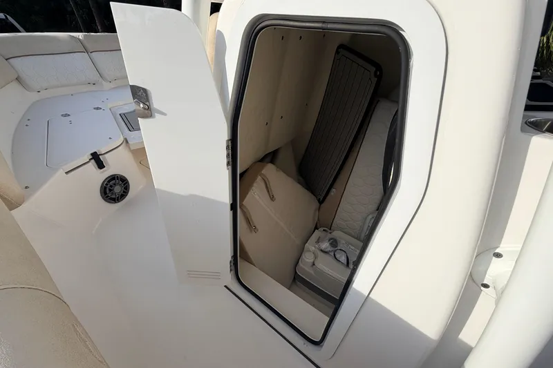 Slide: The Image of 2022 Sea Fox 228 Commander boat storage compartment with open door. - 50