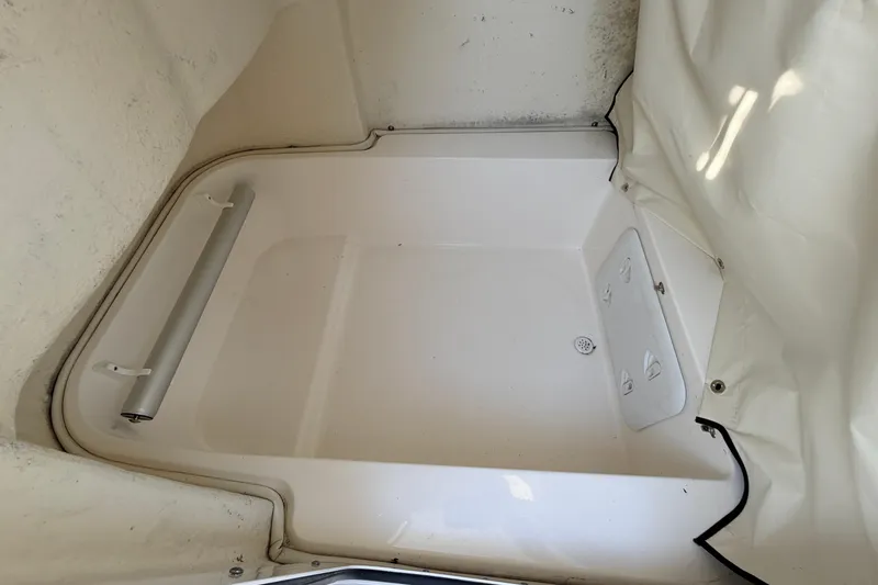 Slide: The Image of 2022 Sea Fox 228 Commander interior compartment with white finish and storage features. - 51