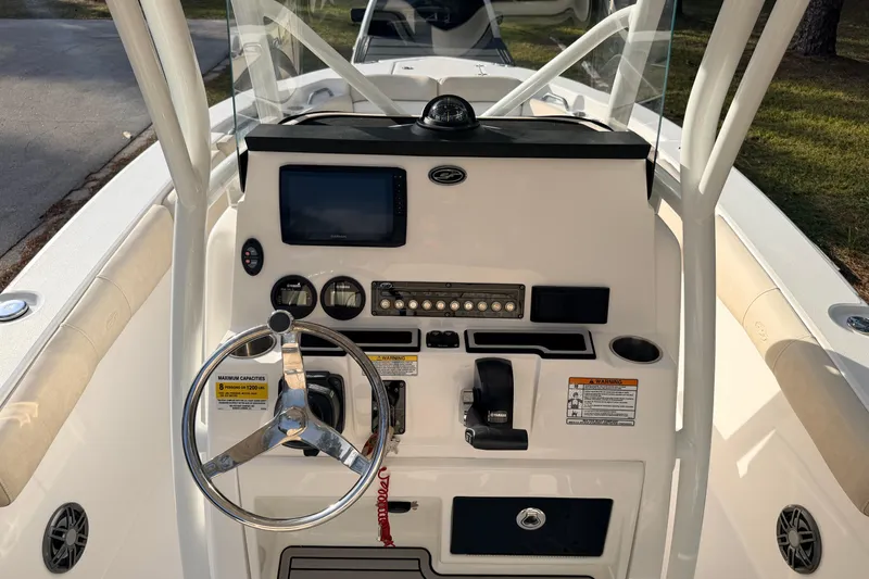 Slide: The Image of 2022 Sea Fox 228 Commander boat console with steering wheel and navigation controls. - 53