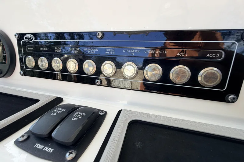Slide: The Image of Control panel of a 2022 Sea Fox 228 Commander boat with labeled switches. - 56