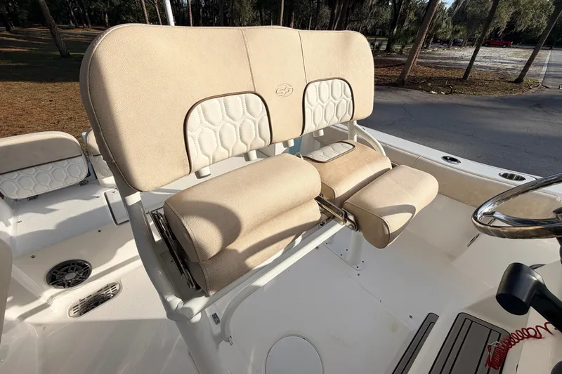 Slide: The Image of 2022 Sea Fox 228 Commander boat seating with beige upholstery and steering wheel. - 61