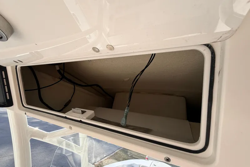 Slide: The Image of 2022 Sea Fox 228 Commander storage compartment with visible wiring. - 70
