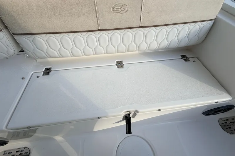 Slide: The Image of 2022 Sea Fox 228 Commander boat seat with white cushioned backrest and storage compartment. - 74