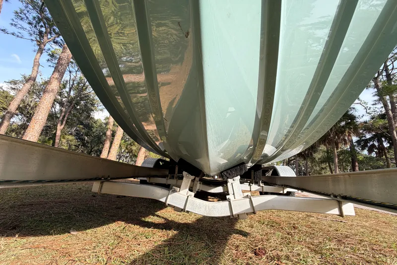 Slide: The Image of Underside view of 2022 Sea Fox 228 Commander boat on trailer, surrounded by trees. - 8
