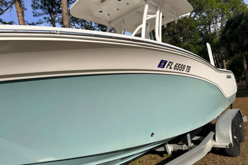 Slide: The Image of 2022 Sea Fox 228 Commander boat on trailer, side view with registration number visible. - 9