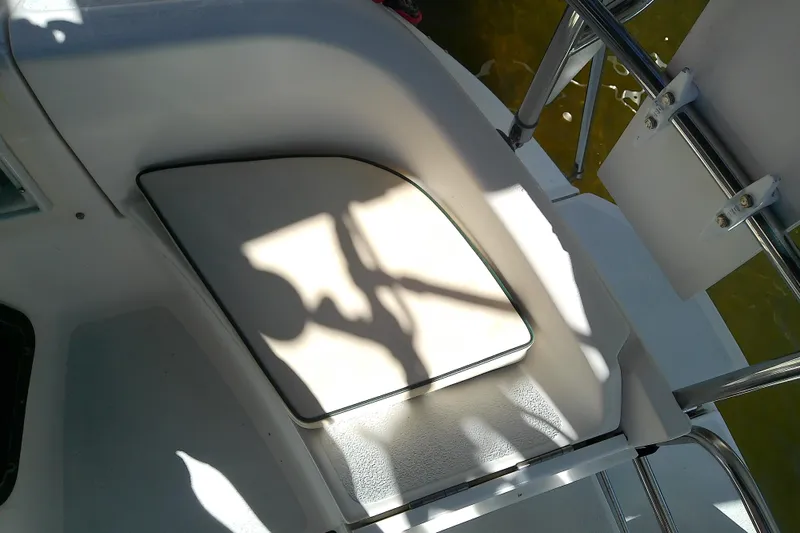 Slide: The Image of 1991 Hunter 30 boat deck with seating and railing in sunlight. - 14