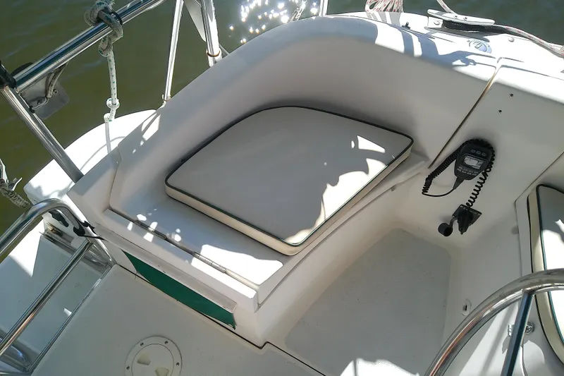 Slide: The Image of Cockpit of 1991 Hunter 30 sailboat with cushioned seating and marine radio. - 15