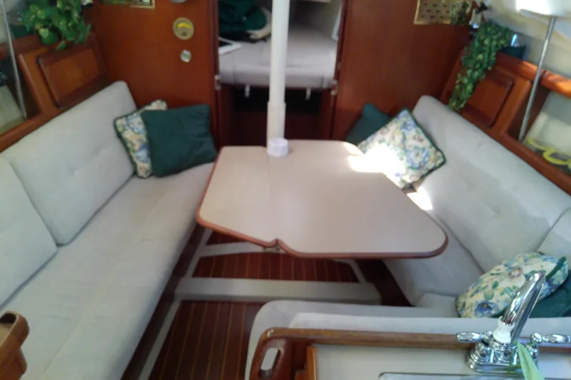 Slide: The Image of Interior of a 1991 Hunter 30 sailboat with cozy seating and table. - 22