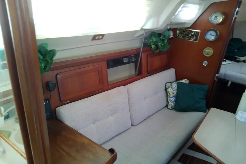 Slide: The Image of Interior of a 1991 Hunter 30 sailboat with cozy seating and nautical decor. - 24