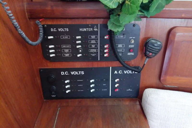 Slide: The Image of Electrical control panel on a 1991 Hunter 30 sailboat, featuring DC and AC volt switches. - 32