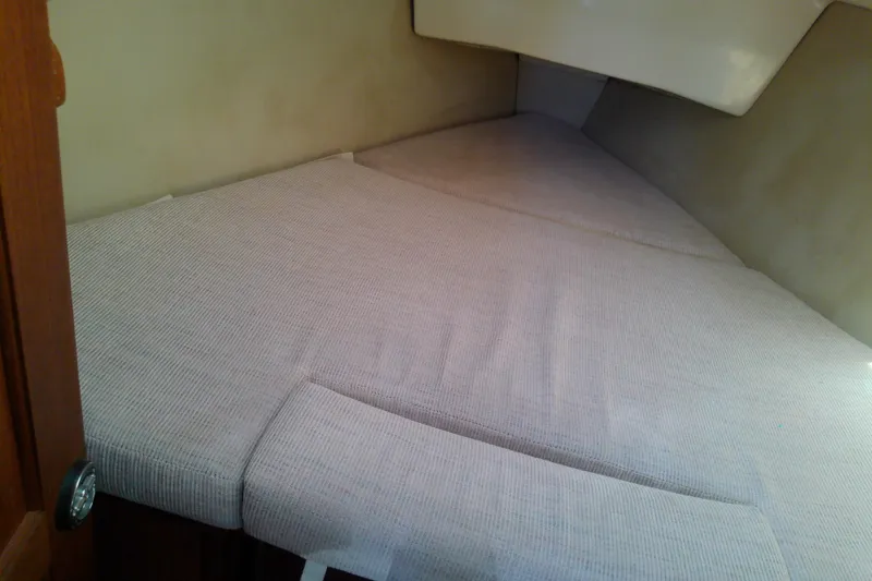 Slide: The Image of Interior cabin of a 1991 Hunter 30 sailboat with cushioned sleeping area. - 38