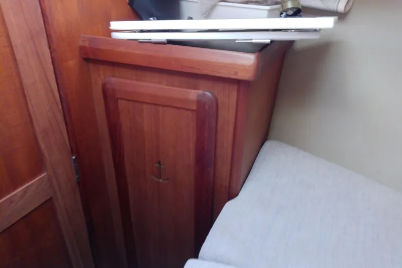 Slide: The Image of Interior of 1991 Hunter 30 sailboat with wooden cabinetry and anchor detail. - 39