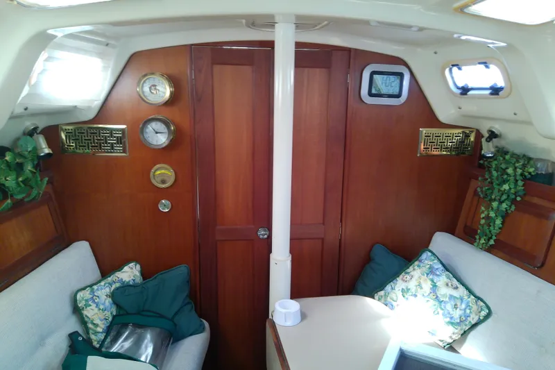 Slide: The Image of Interior of a 1991 Hunter 30 sailboat with wood paneling and cozy seating. - 41