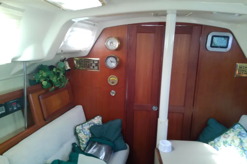 Slide: The Image of Interior of 1991 Hunter 30 sailboat with wood paneling and cozy seating area. - 42