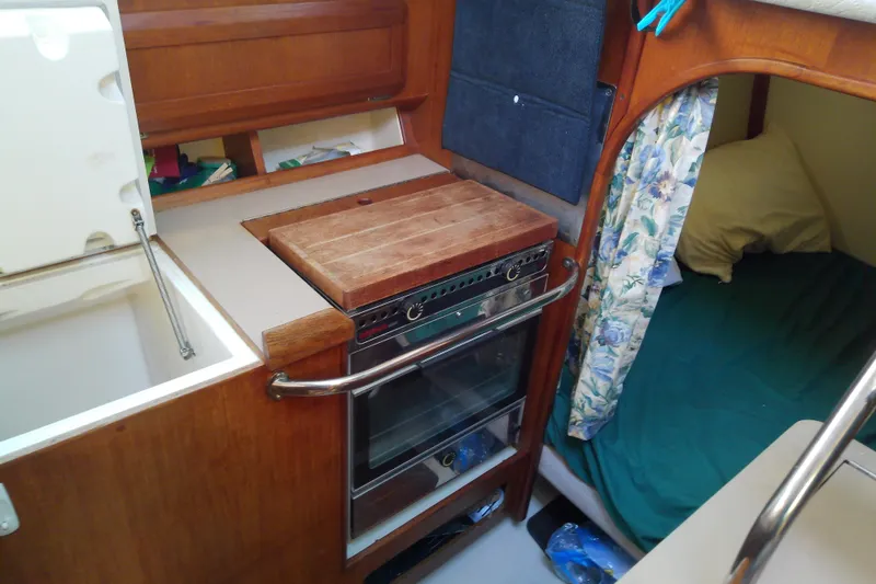 Slide: The Image of 1991 Hunter 30 yacht interior with compact kitchen and cozy sleeping area. - 44