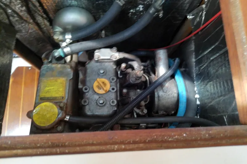 Slide: The Image of Engine compartment of a 1991 Hunter 30 sailboat, showing mechanical components and hoses. - 46