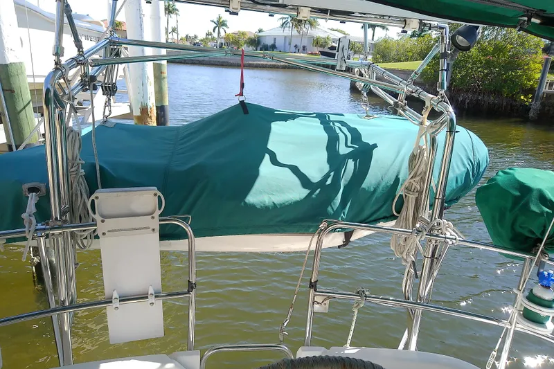 Slide: The Image of Hunter 30 sailboat, 1991 model, docked with green cover, sunny day. - 9