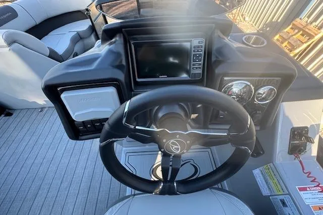 Slide: The Image of 2026 Veranda Relax VR 22 RC boat dashboard with steering wheel and control panel. - 7