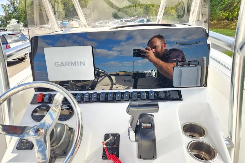 Slide: The Image of 2023 Sea Hunt Ultra 219 dashboard with Garmin display and steering wheel. - 11